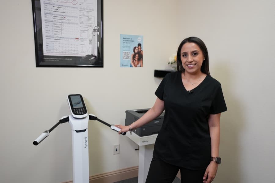 A Soza Clinic team member beside the InBody body composition scanner